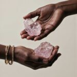woman hands holding rose quartz ccrystal