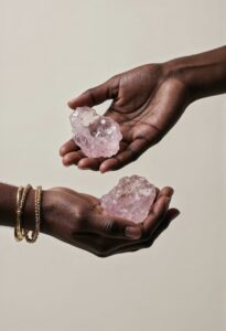 woman hands holding rose quartz ccrystal